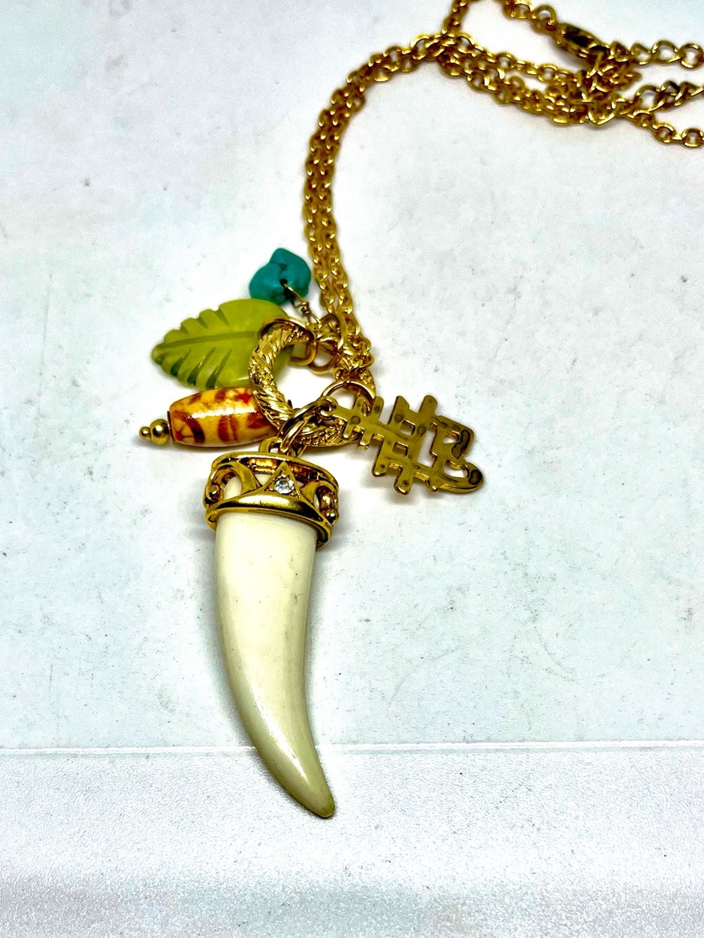 Gold-Tone Necklace with  Horn Pendant and Colored Leaf Charms